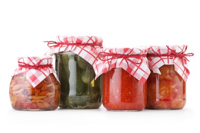 Photo of Many jars with different pickled products isolated on white
