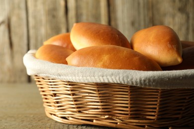 Tasty baked patties on wooden table, closeup