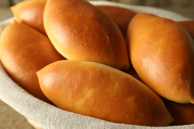 Photo of Tasty baked patties on table, closeup view