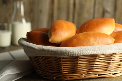 Photo of Tasty baked patties on wooden table, closeup