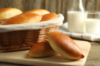 Photo of Tasty baked patties on wooden table, closeup