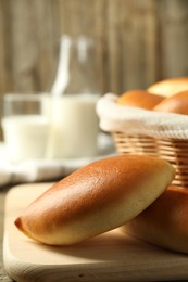 Photo of Tasty baked patties on wooden table, closeup. Space for text