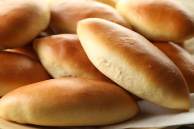 Photo of Many tasty baked patties on table, closeup