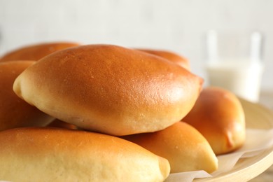 Photo of Many tasty baked patties on table, closeup
