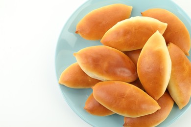 Photo of Many tasty baked patties on white background, top view
