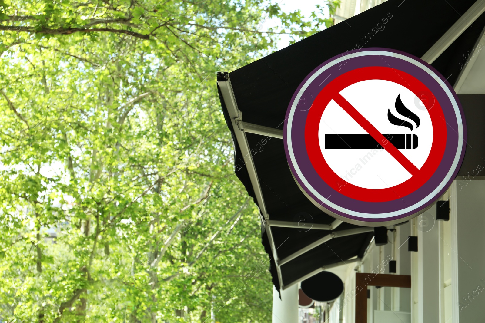 No Smoking sign on building wall outdoors Image of No Smoking sign on building wall outdoors