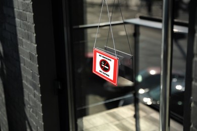 Image of No Smoking sign hanging on entrance door