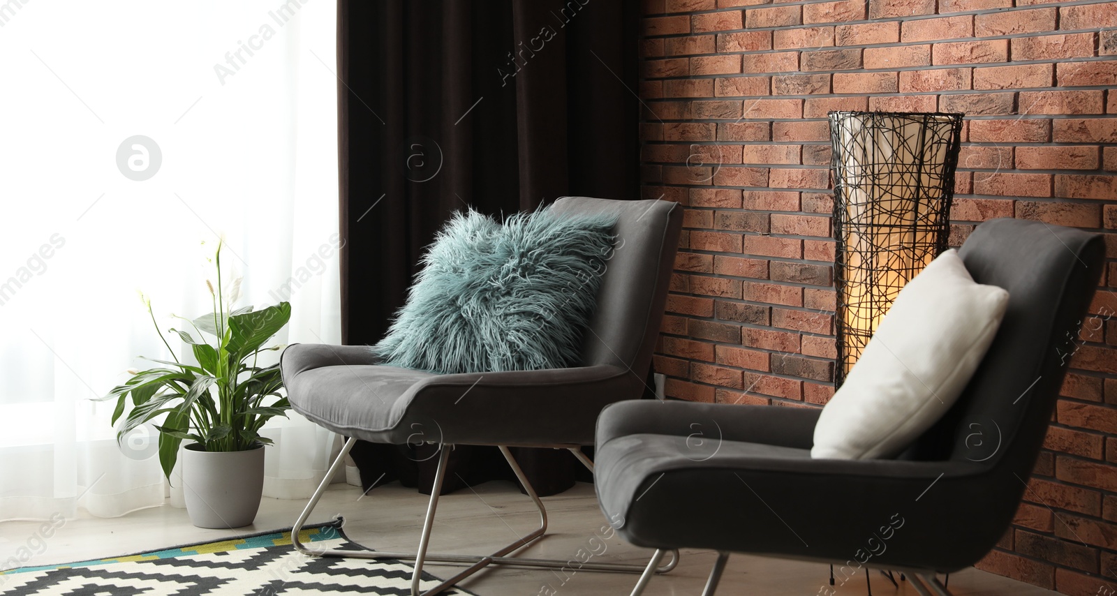 Photo of Comfortable chairs near window with elegant curtains in room