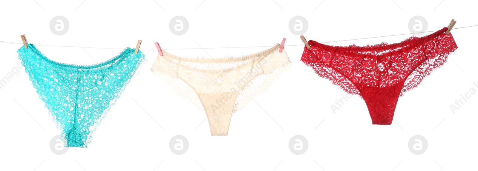 Beautiful panties on clothes line against white background Photo of Beautiful panties on clothes line against white background