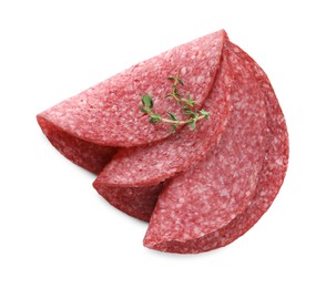 Photo of Slices of tasty smoked sausage with thyme isolated on white, top view