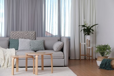 Photo of Window with stylish curtains in living room interior
