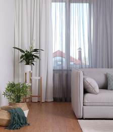 Photo of Window with stylish curtains in living room interior