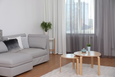 Photo of Window with stylish curtains in living room interior