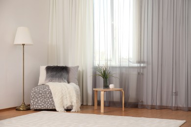 Photo of Window with stylish curtains in living room interior