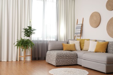 Photo of Window with stylish curtains in living room interior