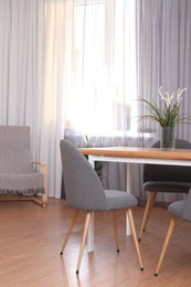 Photo of Window with stylish curtains in living room interior