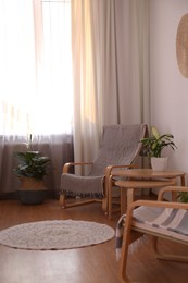 Photo of Window with stylish curtains in living room interior