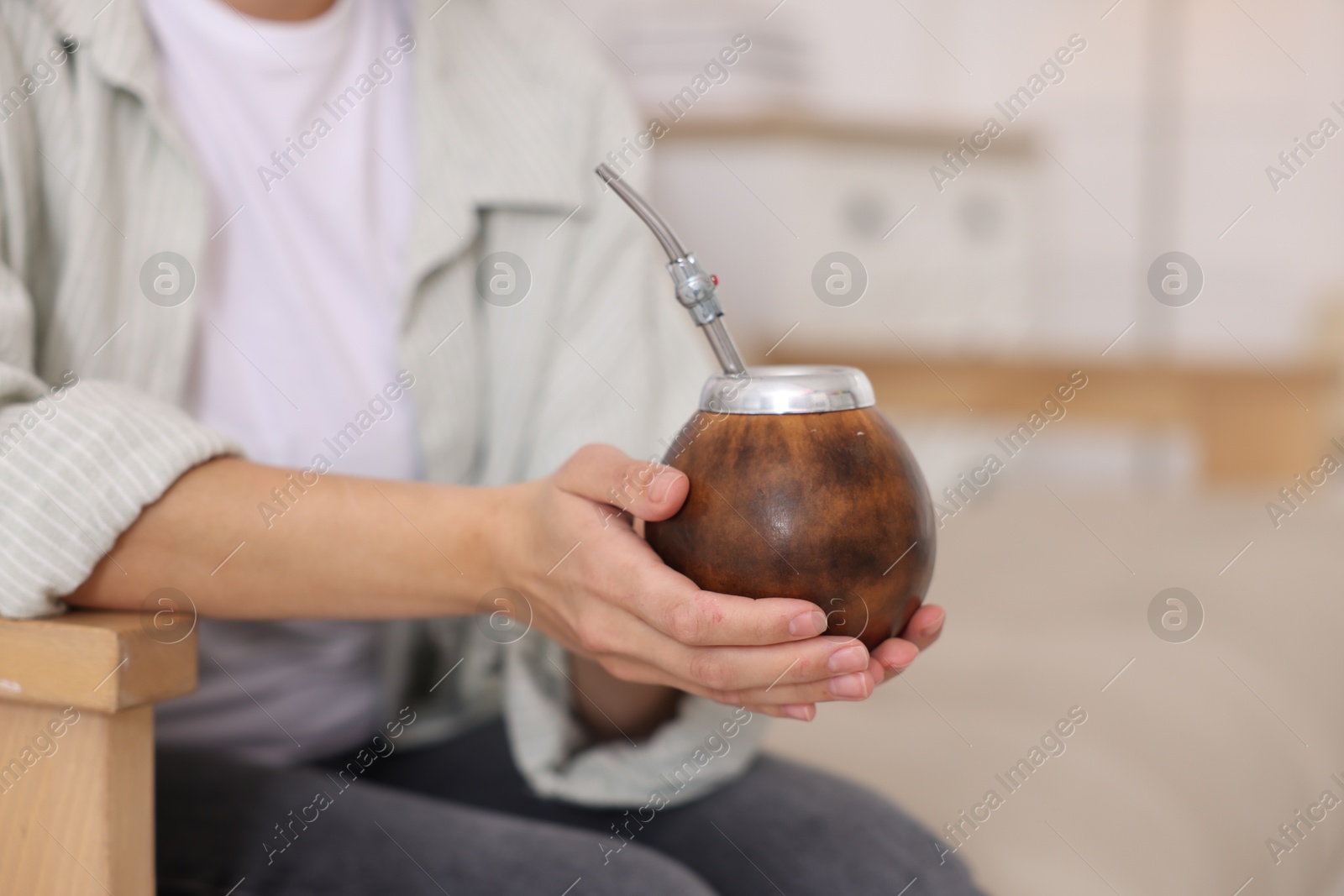 Woman drinking traditional yerba mate tea indoors, closeup. Space for text Photo of Woman drinking traditional yerba mate tea indoors, closeup. Space for text