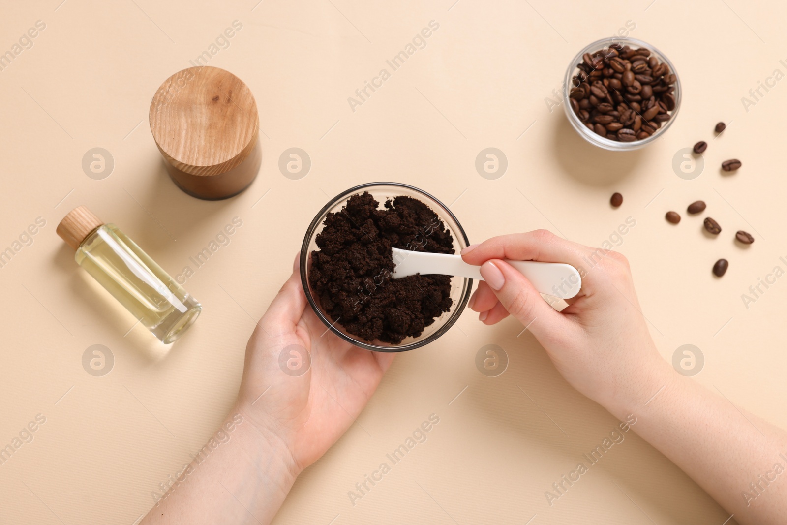 Woman with bowl of body scrub on beige background, top view Photo of Woman with bowl of body scrub on beige background, top view
