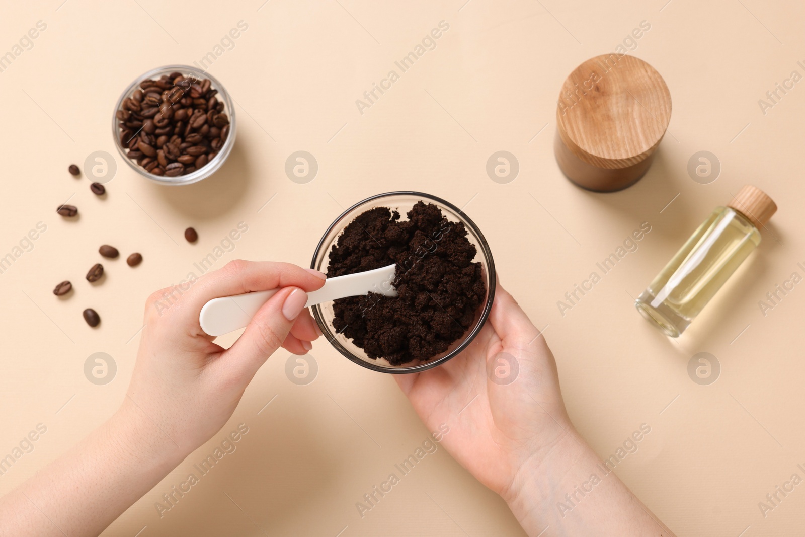 Woman with bowl of body scrub on beige background, top view Photo of Woman with bowl of body scrub on beige background, top view