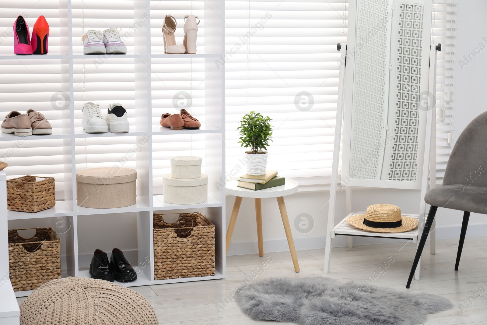 Shoe storage. Shelving unit with different footwear, accessories and mirror indoors Photo of Shoe storage. Shelving unit with different footwear, accessories and mirror indoors