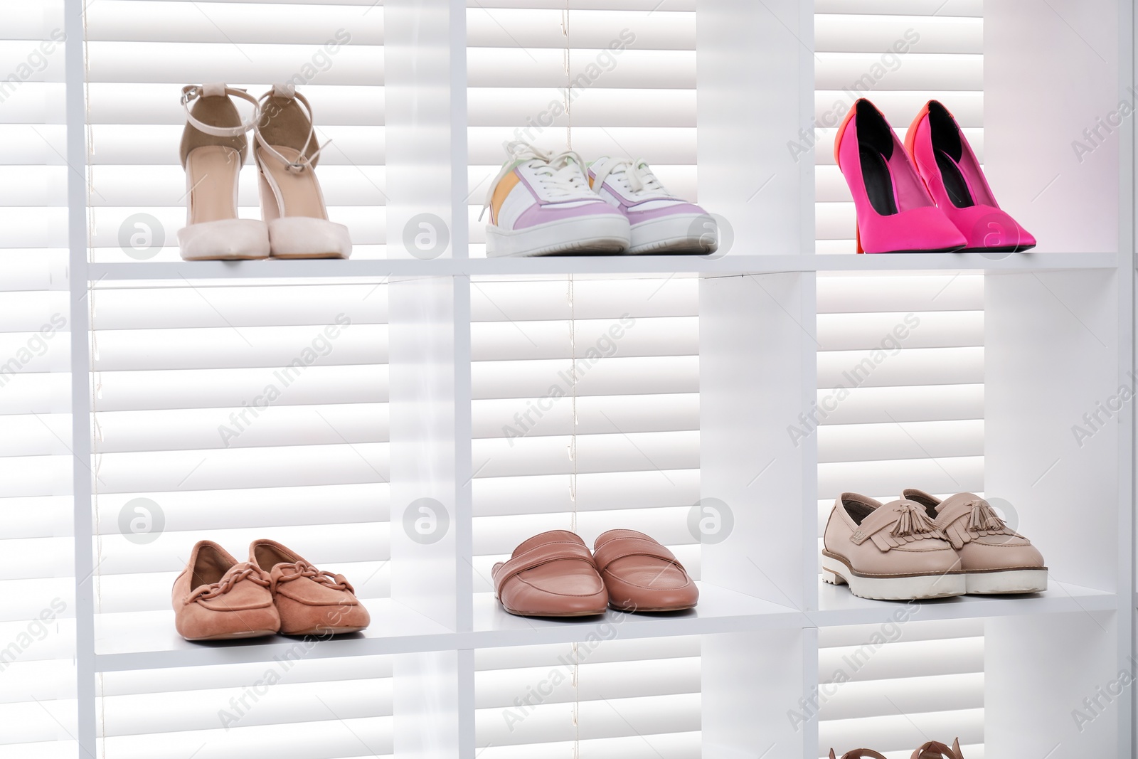 Shoe storage. Shelving unit with different footwear indoors Photo of Shoe storage. Shelving unit with different footwear indoors