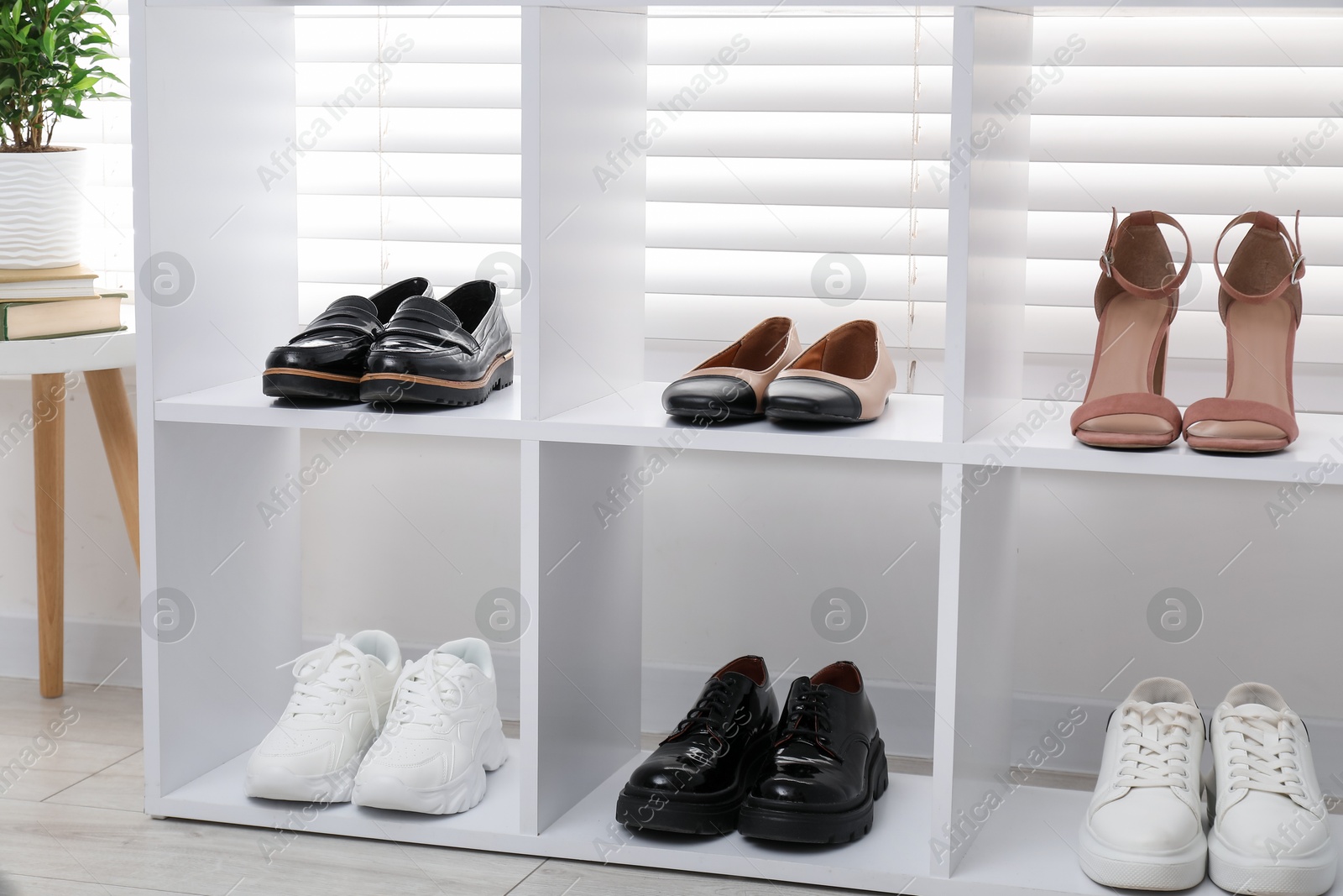 Shoe storage. Shelving unit with different footwear indoors Photo of Shoe storage. Shelving unit with different footwear indoors