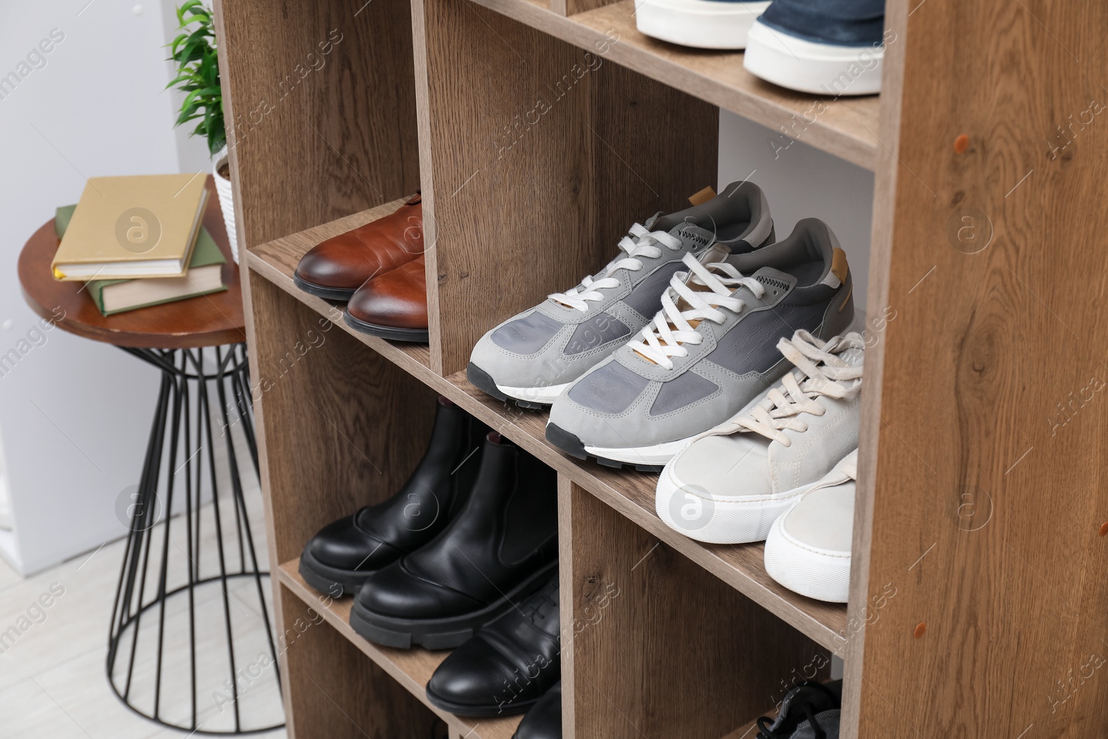 Shoe storage. Shelving unit with different footwear indoors, closeup Photo of Shoe storage. Shelving unit with different footwear indoors, closeup