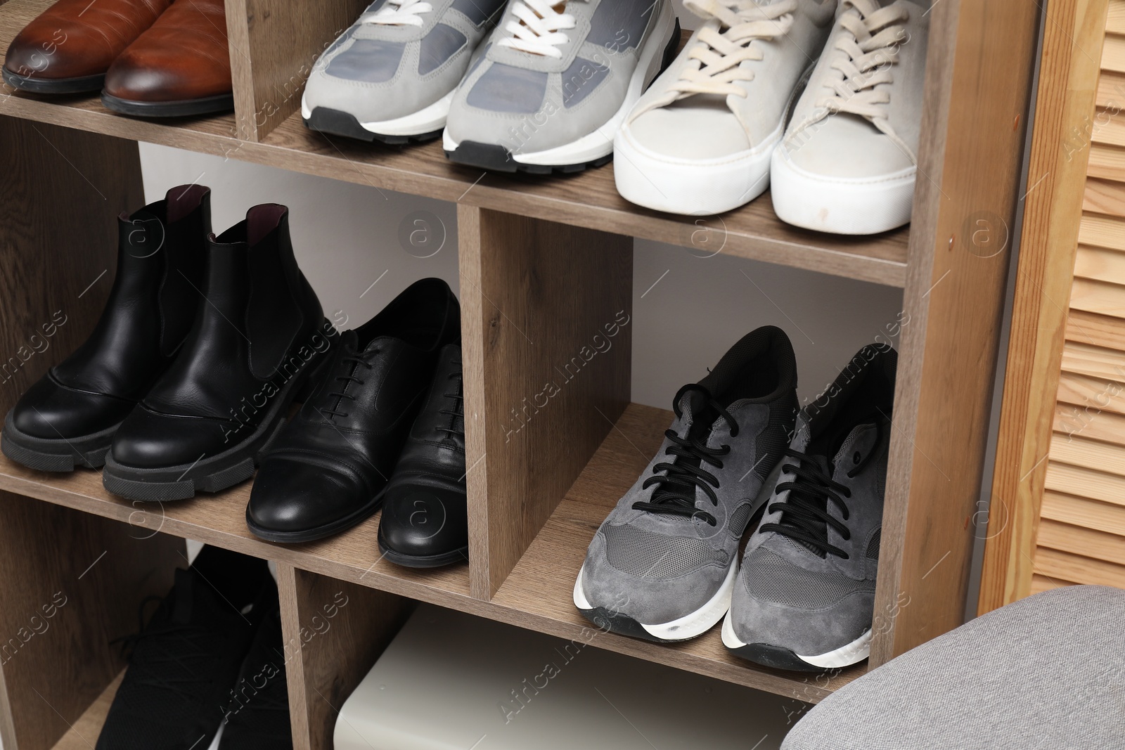 Shoe storage. Shelving unit with different footwear indoors, closeup Photo of Shoe storage. Shelving unit with different footwear indoors, closeup