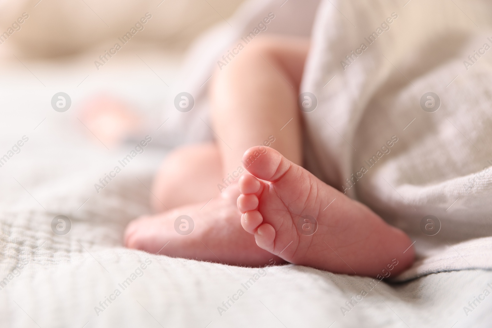 Little baby lying on bed indoors, closeup Photo of Little baby lying on bed indoors, closeup
