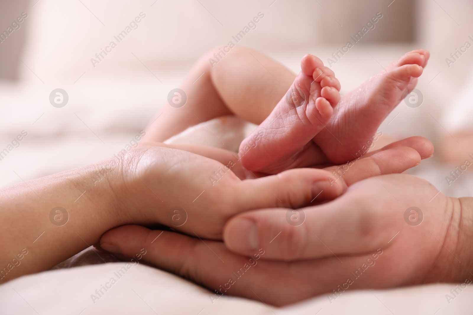 Parents with their little baby on bed indoors, closeup Photo of Parents with their little baby on bed indoors, closeup
