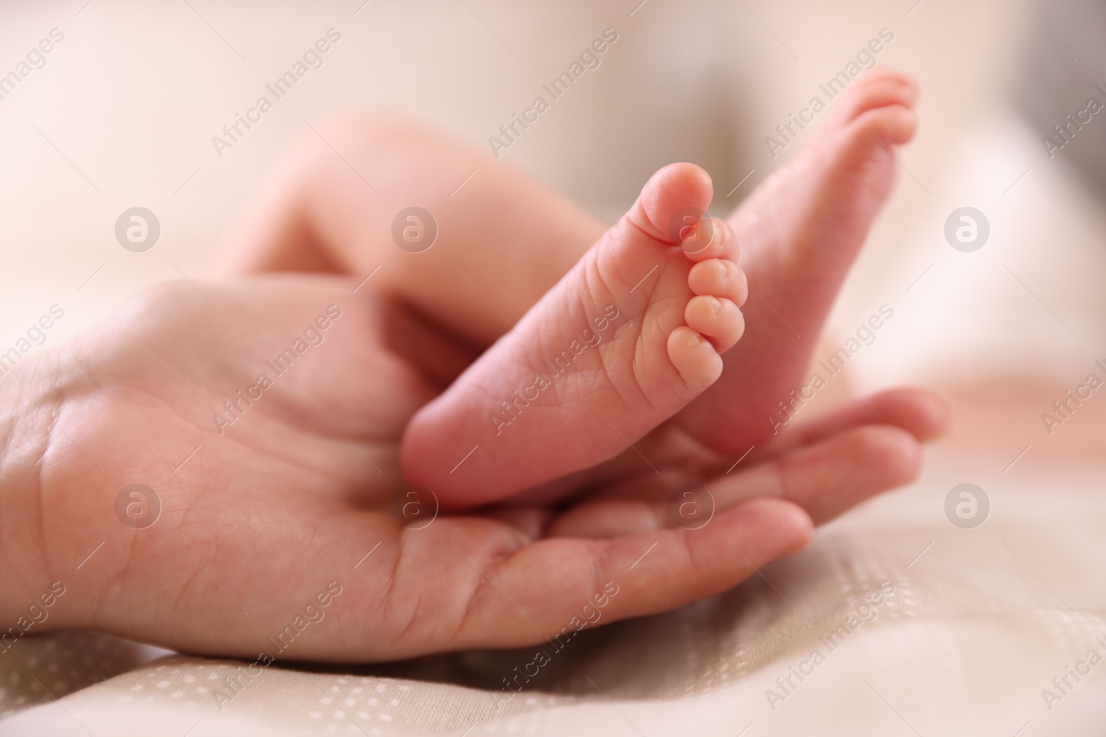 Mother with her little baby on bed indoors, closeup Photo of Mother with her little baby on bed indoors, closeup