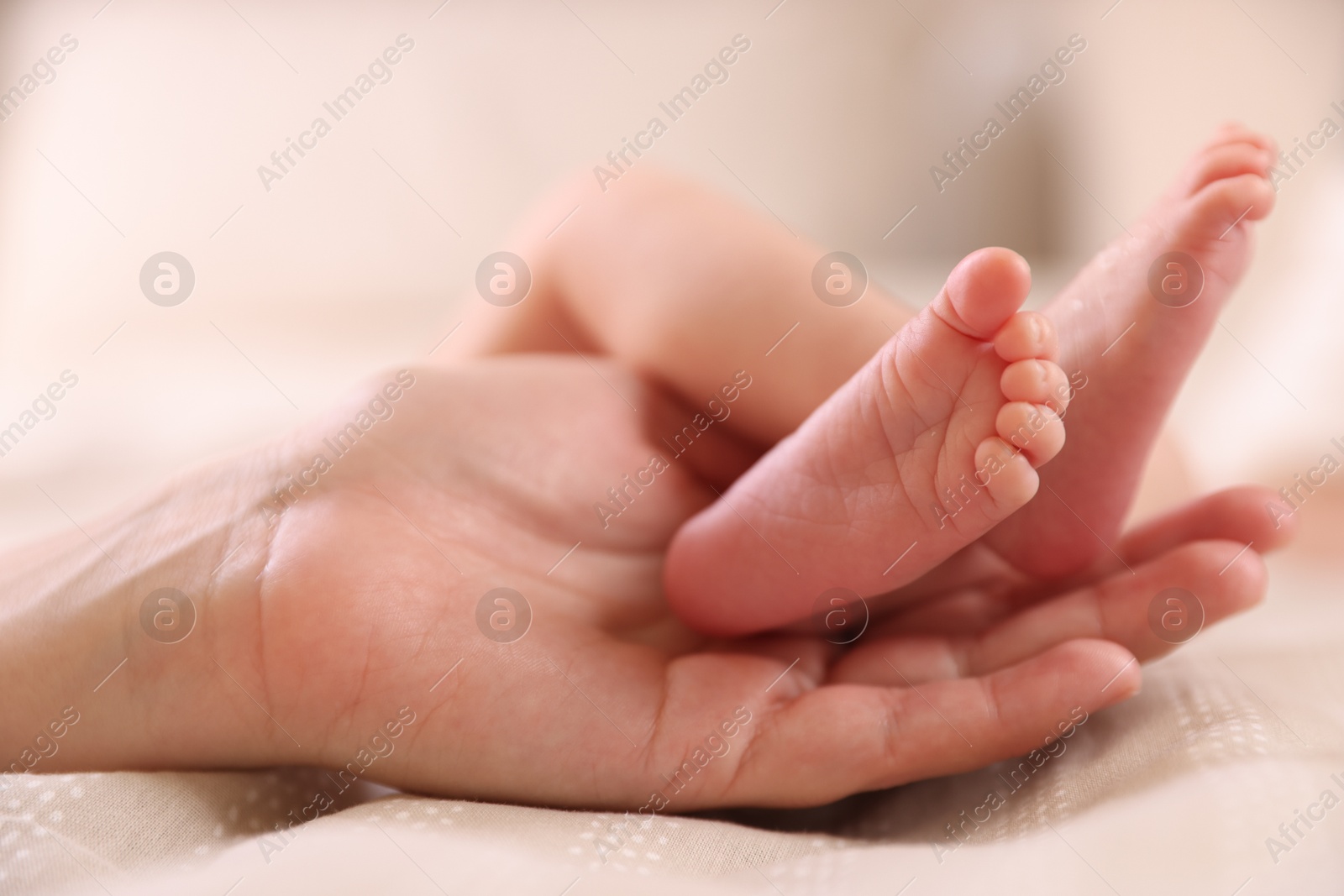 Mother with her little baby on bed indoors, closeup Photo of Mother with her little baby on bed indoors, closeup