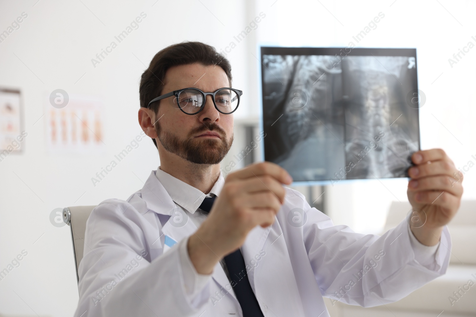 Doctor examining neck MRI scan in clinic Photo of Doctor examining neck MRI scan in clinic