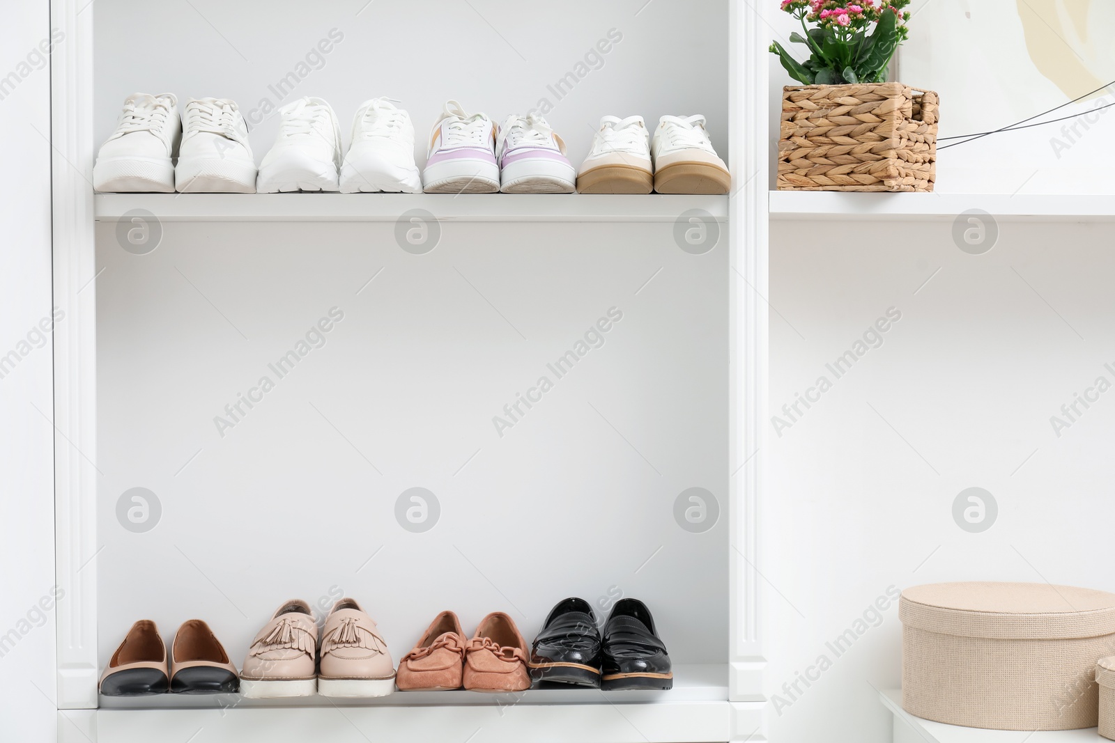 Shoe storage. Different footwear on shelves indoors Photo of Shoe storage. Different footwear on shelves indoors