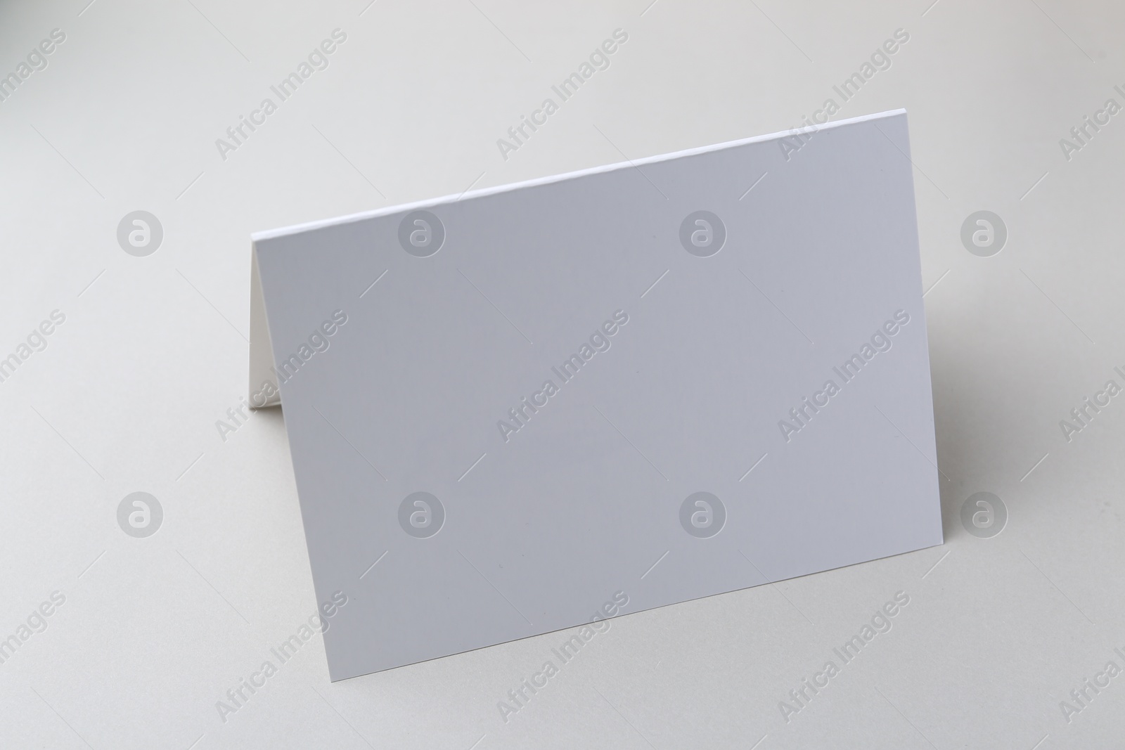 Photo of One blank greeting card on light background