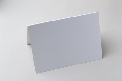 Photo of One blank greeting card on light background