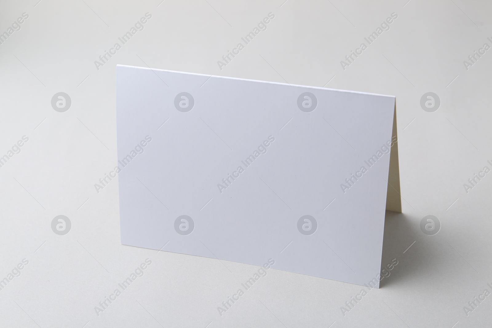 Photo of One blank greeting card on light background
