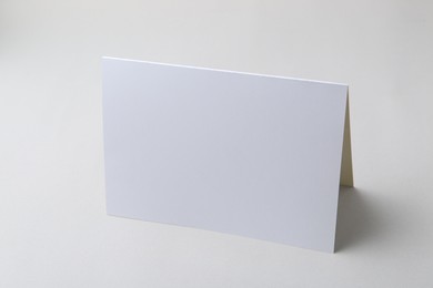 Photo of One blank greeting card on light background