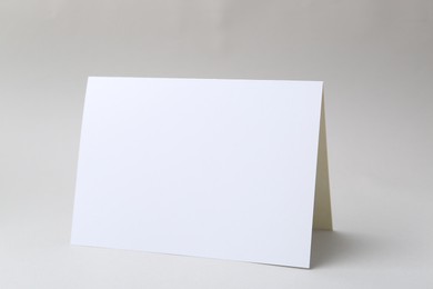 Photo of One blank greeting card on light background