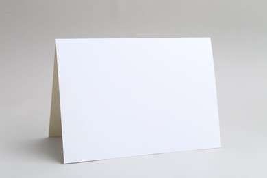 Photo of One blank greeting card on light background