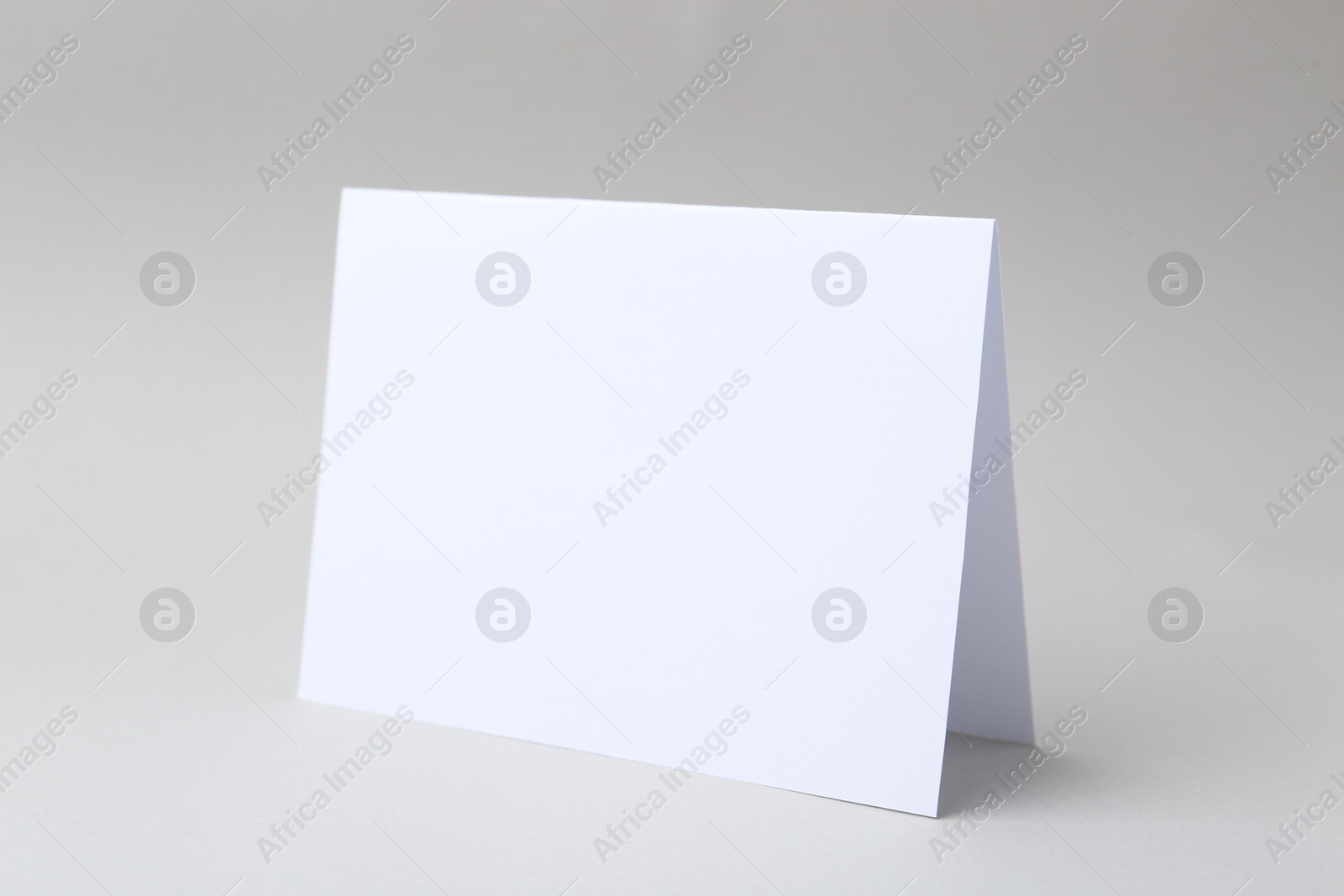 Photo of One blank greeting card on light background