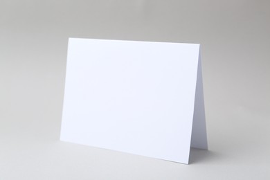 Photo of One blank greeting card on light background