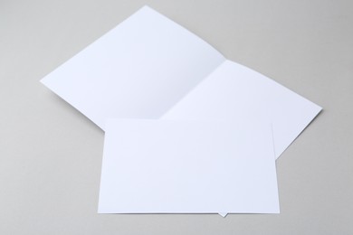Photo of Blank greeting cards on light background, closeup