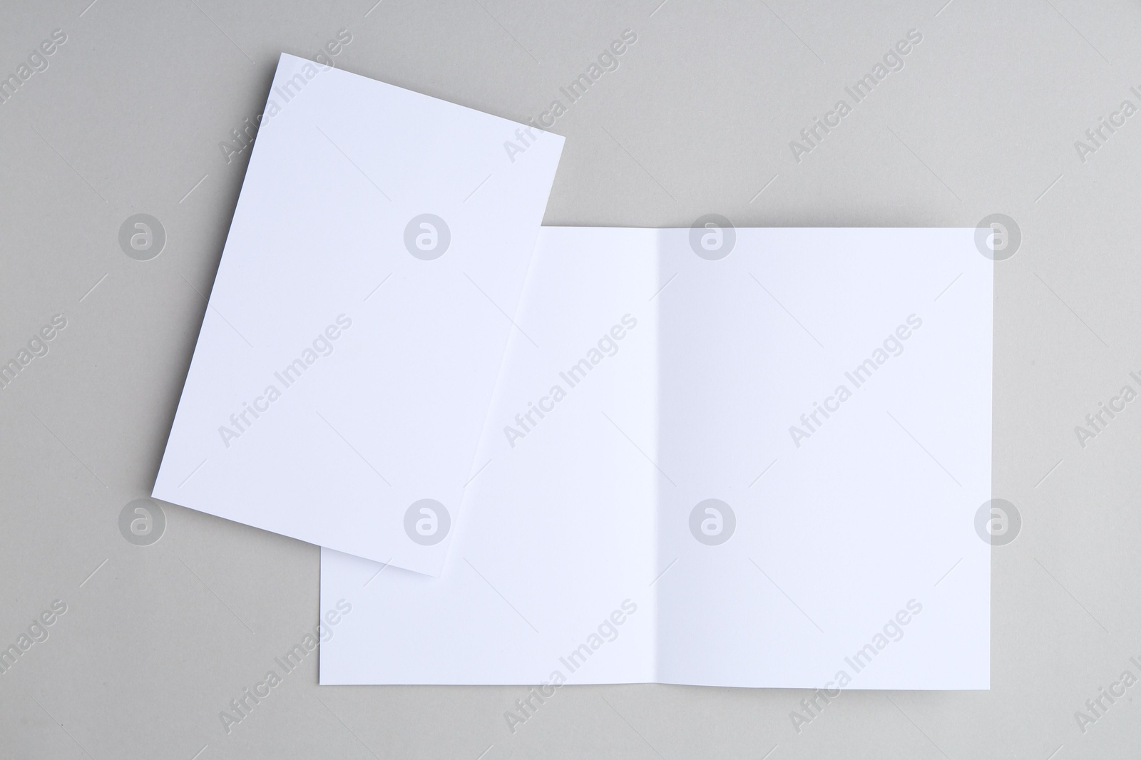 Photo of Blank greeting cards on light background, top view
