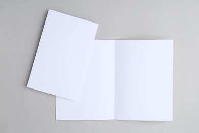 Photo of Blank greeting cards on light background, top view