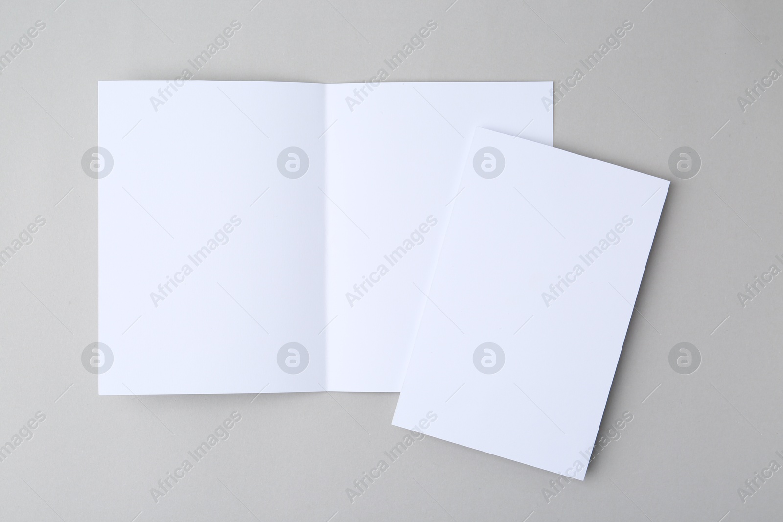 Photo of Blank greeting cards on light background, top view