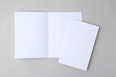 Photo of Blank greeting cards on light background, top view