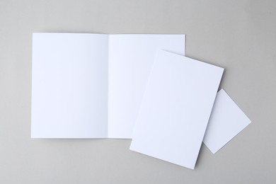 Photo of Blank greeting cards on light background, top view