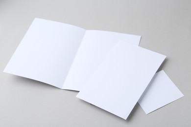 Photo of Blank greeting cards on light background, closeup